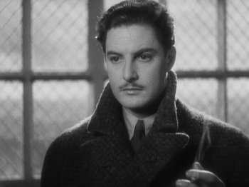 Movie still from “The 39 Steps” (1935), directed by Alfred Hitchcock – A black and white photo of a man smoking a cigarette; Close Up shot, Low angle