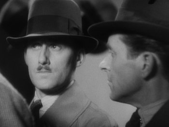 Movie still from “The 39 Steps” (1935), directed by Alfred Hitchcock – A man in a hat and a man in a suit; Close Up shot, High angle