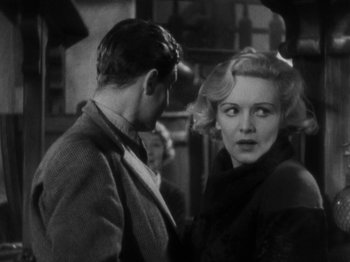 Movie still from “The 39 Steps” (1935), directed by Alfred Hitchcock – A man and a woman standing next to each other; Medium shot, Over the shoulder angle