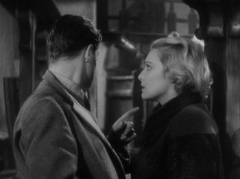 Movie still from “The 39 Steps” (1935), directed by Alfred Hitchcock – A man and a woman talking to each other; Medium shot, Over the shoulder angle