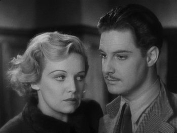 Movie still from “The 39 Steps” (1935), directed by Alfred Hitchcock – A man and a woman standing next to each other; Close Up shot, High angle