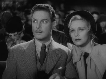 Movie still from “The 39 Steps” (1935), directed by Alfred Hitchcock – A man and a woman standing next to each other; Close Up shot, High angle