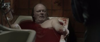Movie still from “Department Q: The Absent One” (2014), directed by Mikkel Nørgaard – A man in a bathtub with blood on his face; Medium shot, High angle