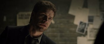 Movie still from “Department Q: The Absent One” (2014), directed by Mikkel Nørgaard – A person wearing a suit and tie; Close Up shot, Low angle