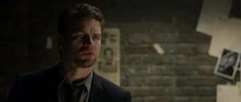 Movie still from “Department Q: The Absent One” (2014), directed by Mikkel Nørgaard – A person wearing a suit and tie; Close Up shot, Over the shoulder angle