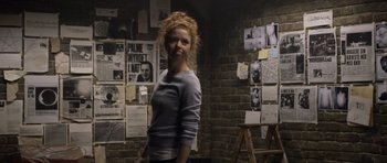 Movie still from “Department Q: The Absent One” (2014), directed by Mikkel Nørgaard – A woman standing in front of a brick wall; Medium shot, Low angle