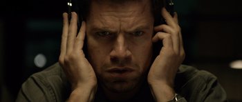 Movie still from “Department Q: The Absent One” (2014), directed by Mikkel Nørgaard – A person with headphones on; Close Up shot, Overhead angle