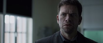 Movie still from “Department Q: The Absent One” (2014), directed by Mikkel Nørgaard – A person wearing a black shirt; Close Up shot, Low angle