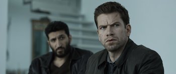 Movie still from “Department Q: The Absent One” (2014), directed by Mikkel Nørgaard – Two men are standing next to each other; Close Up shot, Over the shoulder angle