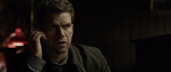 Movie still from “Department Q: The Absent One” (2014), directed by Mikkel Nørgaard – A person wearing a jacket; Close Up shot, Over the shoulder angle