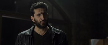 Movie still from “Department Q: The Absent One” (2014), directed by Mikkel Nørgaard – A man with a beard wearing a leather jacket; Close Up shot, Over the shoulder angle