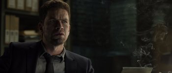 Movie still from “Department Q: The Absent One” (2014), directed by Mikkel Nørgaard – A person wearing a suit and tie; Close Up shot, Low angle