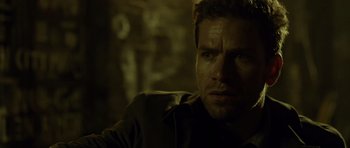 Movie still from “Department Q: The Absent One” (2014), directed by Mikkel Nørgaard – A man's face in a dark room; Close Up shot, Over the shoulder angle