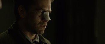 Movie still from “Department Q: The Absent One” (2014), directed by Mikkel Nørgaard – A person with a bandage on his face; Close Up shot, Over the shoulder angle