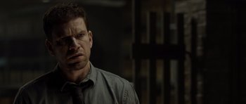 Movie still from “Department Q: The Absent One” (2014), directed by Mikkel Nørgaard – A person wearing a shirt and a tie; Close Up shot, Over the shoulder angle