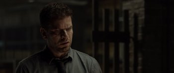 Movie still from “Department Q: The Absent One” (2014), directed by Mikkel Nørgaard – A person wearing a shirt and a tie; Close Up shot, Over the shoulder angle