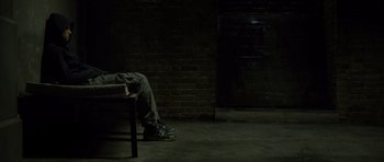 Movie still from “Department Q: The Absent One” (2014), directed by Mikkel Nørgaard – A person sitting on a chair in a dark room; Wide shot, High angle
