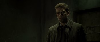 Movie still from “Department Q: The Absent One” (2014), directed by Mikkel Nørgaard – A man in a suit and tie standing in front of a wall; Close Up shot, Over the shoulder angle