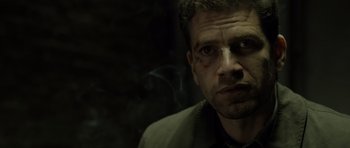 Movie still from “Department Q: The Absent One” (2014), directed by Mikkel Nørgaard – A person wearing a suit and tie; Close Up shot, Low angle