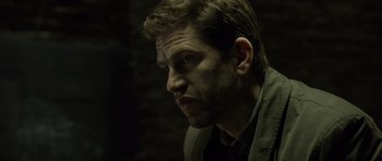 Movie still from “Department Q: The Absent One” (2014), directed by Mikkel Nørgaard – A person wearing a jacket; Close Up shot, Over the shoulder angle