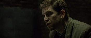 Movie still from “Department Q: The Absent One” (2014), directed by Mikkel Nørgaard – A person looking at the camera; Close Up shot, Over the shoulder angle