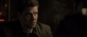 Movie still from “Department Q: The Absent One” (2014), directed by Mikkel Nørgaard – A person wearing a suit and tie; Close Up shot, Over the shoulder angle