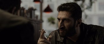 Movie still from “Department Q: The Absent One” (2014), directed by Mikkel Nørgaard – A person holding a cigarette in his mouth; Close Up shot, Over the shoulder angle