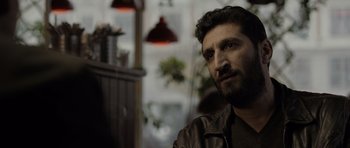 Movie still from “Department Q: The Absent One” (2014), directed by Mikkel Nørgaard – A person wearing a jacket; Close Up shot, Over the shoulder angle