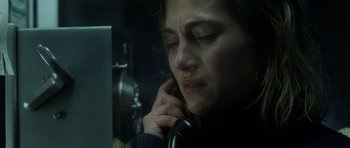 Movie still from “Department Q: The Absent One” (2014), directed by Mikkel Nørgaard – A woman on the phone in a dark room; Close Up shot, High angle