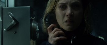 Movie still from “Department Q: The Absent One” (2014), directed by Mikkel Nørgaard – A woman on the phone in a dark room; Close Up shot, Low angle
