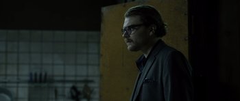 Movie still from “Department Q: The Absent One” (2014), directed by Mikkel Nørgaard – A man in a suit and glasses looking to his left; Close Up shot, Low angle