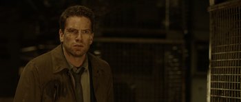 Movie still from “Department Q: The Absent One” (2014), directed by Mikkel Nørgaard – A person wearing a suit and tie; Close Up shot, Low angle