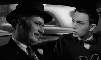 Movie still from “The Absent Minded Professor” (1961), directed by Robert Stevenson – A man and a woman in a car talking to each other; Close Up shot, Over the shoulder angle