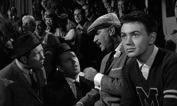 Movie still from “The Absent Minded Professor” (1961), directed by Robert Stevenson – A black and white photo of a group of men in suits and hats; Medium shot, Low angle