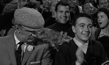 Movie still from “The Absent Minded Professor” (1961), directed by Robert Stevenson – A group of people sitting in front of each other; Medium shot, Over the shoulder angle