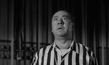 Movie still from “The Absent Minded Professor” (1961), directed by Robert Stevenson – A man in a referee's striped shirt looking up; Close Up shot, Low angle