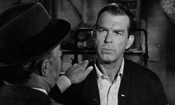 Movie still from “The Absent Minded Professor” (1961), directed by Robert Stevenson – An older man is being examined by an older gentleman; Close Up shot, Over the shoulder angle