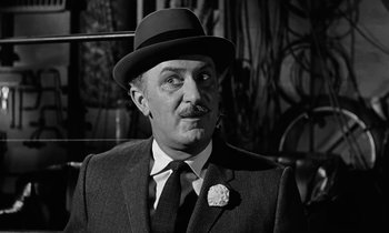 Movie still from “The Absent Minded Professor” (1961), directed by Robert Stevenson – An older man wearing a suit and a hat; Close Up shot, Over the shoulder angle