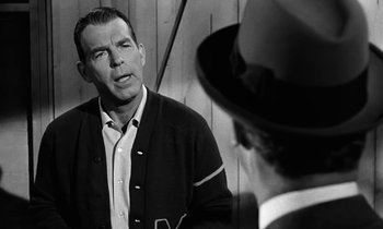 Movie still from “The Absent Minded Professor” (1961), directed by Robert Stevenson – An old photo of a man talking to another man; Close Up shot, Over the shoulder angle