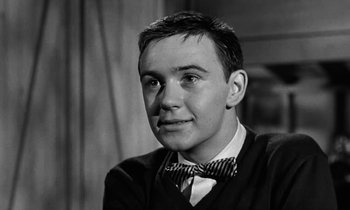 Movie still from “The Absent Minded Professor” (1961), directed by Robert Stevenson – Black and white photograph of a young man wearing a bow tie; Close Up shot, Low angle