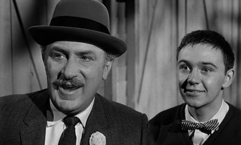 Movie still from “The Absent Minded Professor” (1961), directed by Robert Stevenson – A black and white photo of a man and a woman; Close Up shot, Over the shoulder angle