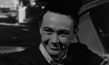 Movie still from “The Absent Minded Professor” (1961), directed by Robert Stevenson – A black and white photo of a man smiling; Close Up shot, High angle