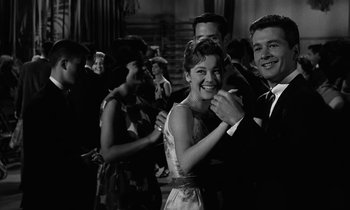 Movie still from “The Absent Minded Professor” (1961), directed by Robert Stevenson – A man and a woman dancing in front of a crowd; Medium shot, Low angle