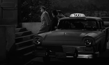 Movie still from “The Absent Minded Professor” (1961), directed by Robert Stevenson – A black and white photo of a taxi cab; Wide shot, High angle