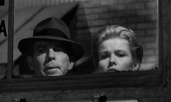 Movie still from “The Absent Minded Professor” (1961), directed by Robert Stevenson – A black and white photo of a man and a woman; Close Up shot, Low angle