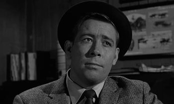 Movie still from “The Absent Minded Professor” (1961), directed by Robert Stevenson – A black and white photo of a man wearing a suit and a hat; Close Up shot, Low angle