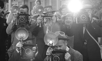 Movie still from “The Absent Minded Professor” (1961), directed by Robert Stevenson – A group of people taking pictures with old cameras; Extreme Close Up shot, High angle