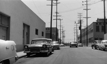 Movie still from “The Absent Minded Professor” (1961), directed by Robert Stevenson – A black and white photo of cars parked on the side of the road; Extreme Wide shot, Low angle