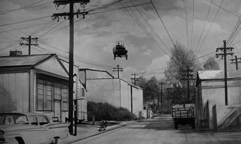 Movie still from “The Absent Minded Professor” (1961), directed by Robert Stevenson – An old photo of a car flying through the air over a city street; Extreme Wide shot, Low angle