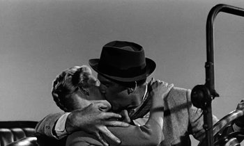 Movie still from “The Absent Minded Professor” (1961), directed by Robert Stevenson – A man and a woman are kissing in a black and white photo; Close Up shot, Low angle